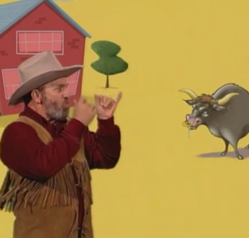 Man in a cowboy outfit signing in front of a cartoon of a barn and bull